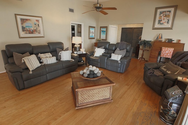 living room featuring ceiling fan and light hardwood / wood-style floors