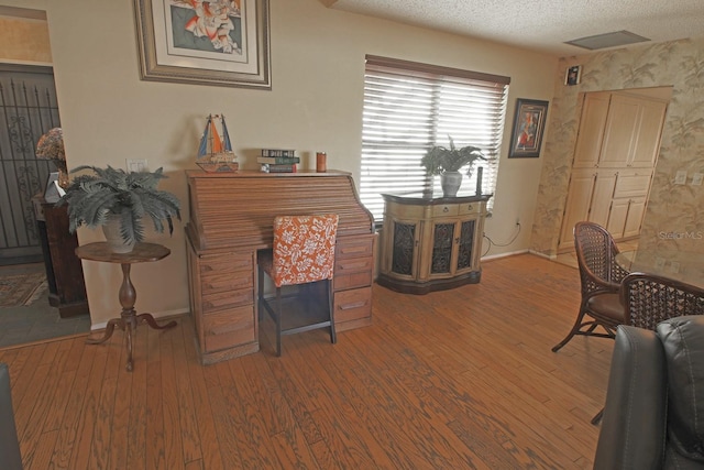 interior space featuring a textured ceiling and dark hardwood / wood-style flooring