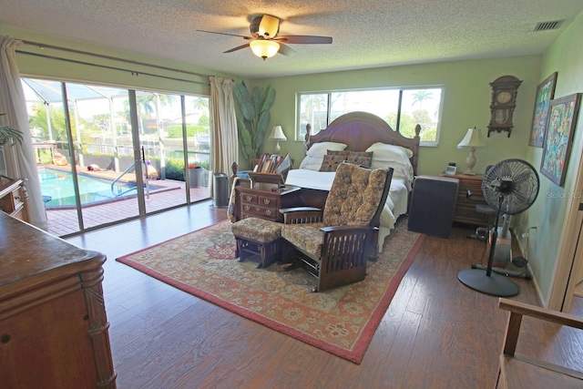 interior space featuring dark hardwood / wood-style flooring, a wealth of natural light, ceiling fan, and a textured ceiling