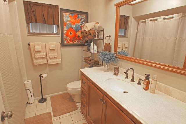 bathroom with vanity, toilet, curtained shower, and tile patterned floors