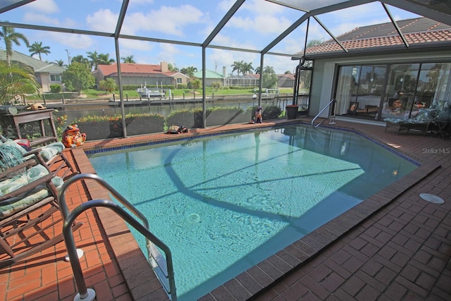 view of pool featuring a water view, a patio area, and a lanai