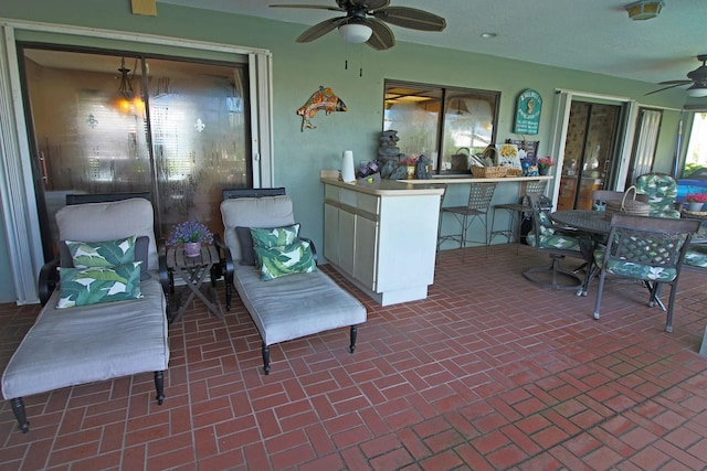 view of patio featuring a bar and ceiling fan