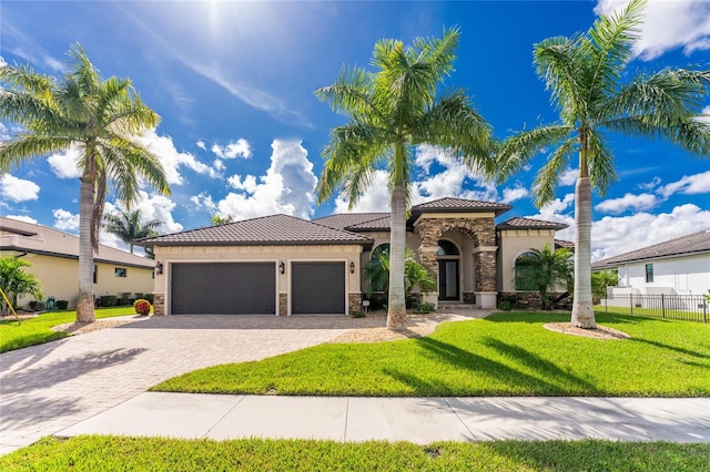 mediterranean / spanish-style home with a front lawn and a garage