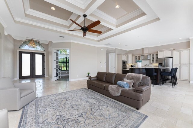 living room featuring coffered ceiling, beamed ceiling, crown molding, ceiling fan, and french doors