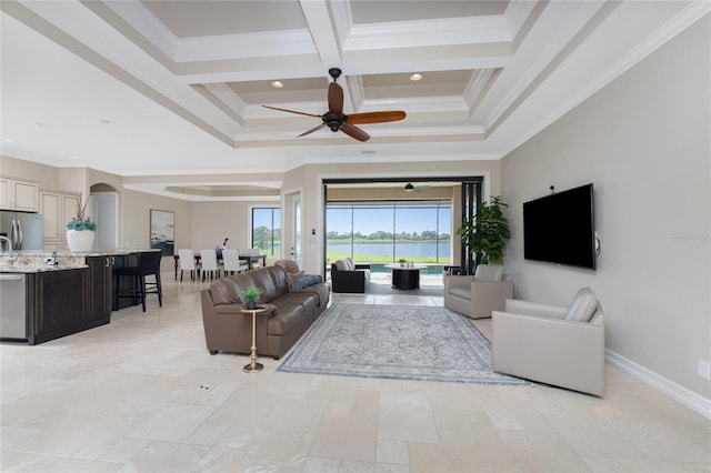 living room featuring ceiling fan, beamed ceiling, ornamental molding, and coffered ceiling