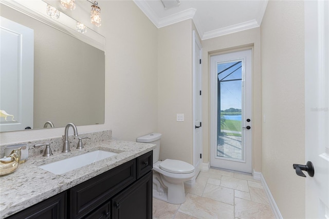 bathroom featuring crown molding, vanity, and toilet