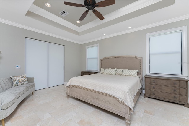 bedroom with ceiling fan, a raised ceiling, and crown molding