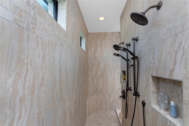 bathroom with a tile shower