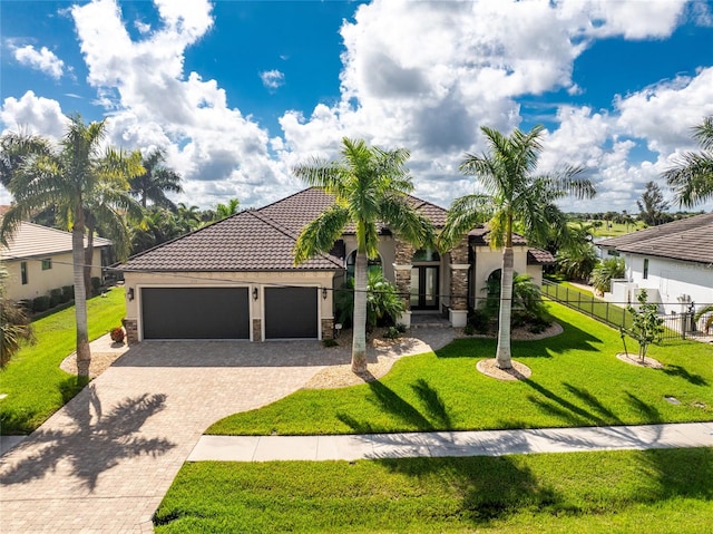 mediterranean / spanish-style house with a front lawn and a garage