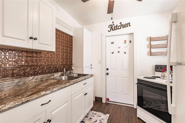 kitchen with white cabinetry, dark stone countertops, dark wood-type flooring, sink, and white appliances