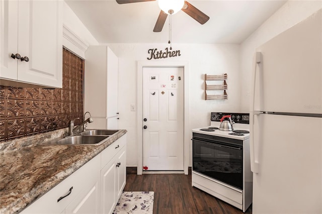 kitchen featuring white appliances, sink, white cabinets, dark stone countertops, and dark wood-type flooring