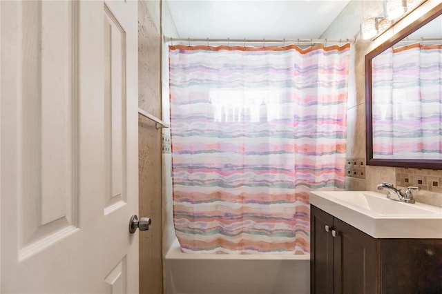 bathroom featuring vanity, shower / tub combo, and backsplash