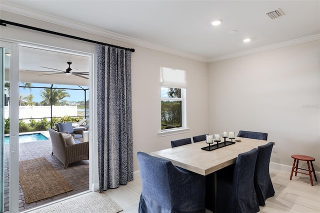 dining area with ornamental molding and ceiling fan