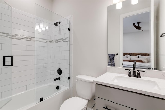 full bathroom with vanity, tiled shower / bath combo, and toilet