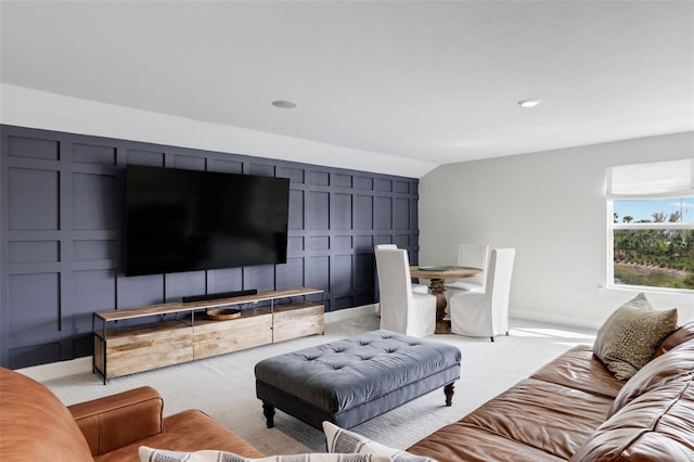 carpeted living room featuring vaulted ceiling