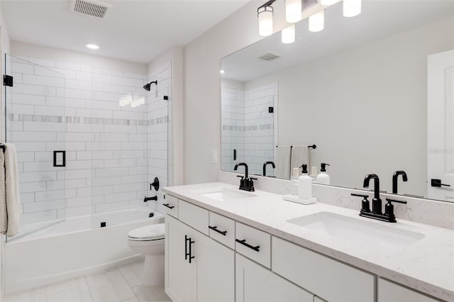 full bathroom featuring vanity, bath / shower combo with glass door, toilet, and tile patterned floors