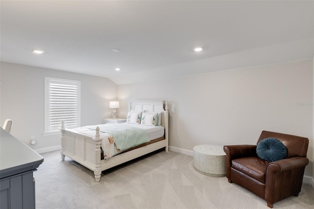 carpeted bedroom with lofted ceiling