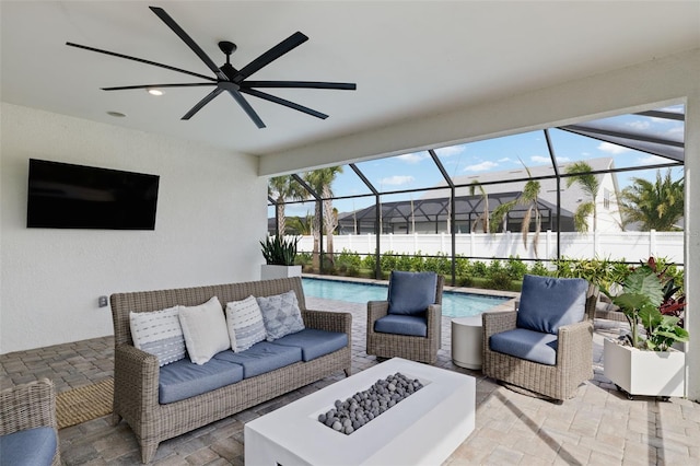 view of patio / terrace featuring ceiling fan, a lanai, a fenced in pool, and outdoor lounge area