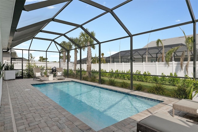 view of pool with a patio and a lanai