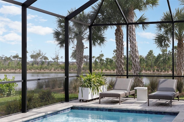 view of swimming pool with a water view, a patio, and glass enclosure