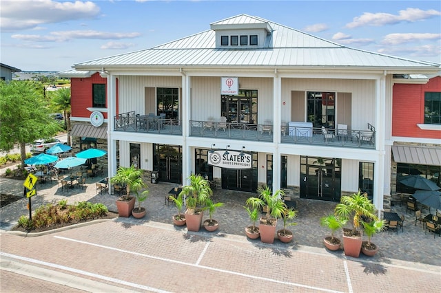 back of property with a balcony