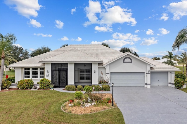 single story home featuring a garage and a front yard