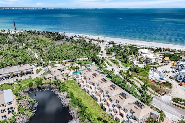 drone / aerial view featuring a beach view and a water view