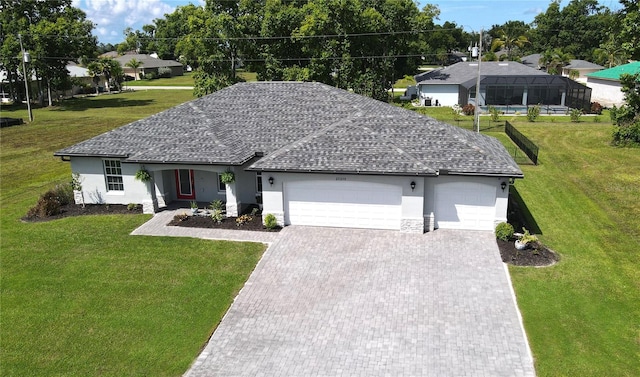 ranch-style home with a garage and a front lawn