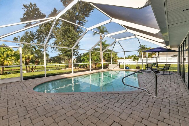 view of swimming pool with a lanai and a patio area