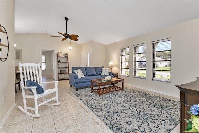 living room featuring lofted ceiling, light tile patterned floors, and ceiling fan