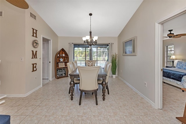 tiled dining space with lofted ceiling and ceiling fan with notable chandelier