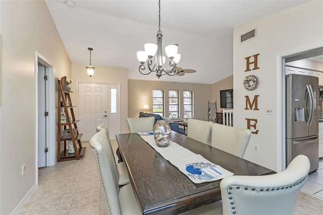 dining area featuring light tile patterned floors, a chandelier, and vaulted ceiling