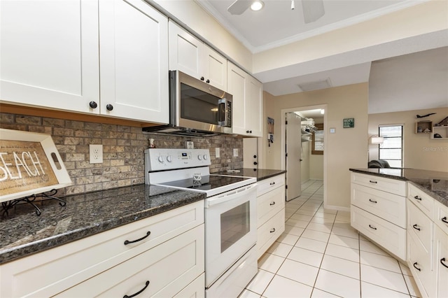 kitchen featuring dark stone countertops, crown molding, electric range, white cabinetry, and ceiling fan