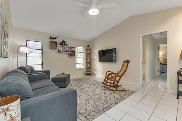 tiled living room with ceiling fan, a wealth of natural light, and vaulted ceiling