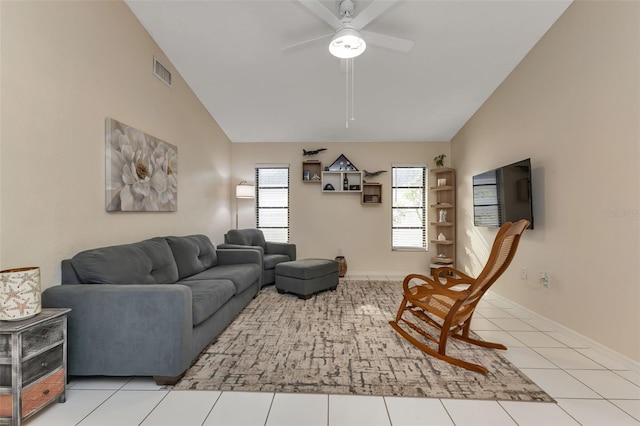 living room with lofted ceiling, ceiling fan, and tile patterned floors