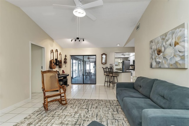 living room with vaulted ceiling, light tile patterned flooring, and ceiling fan