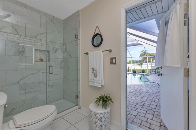 bathroom with an enclosed shower, tile patterned flooring, and toilet