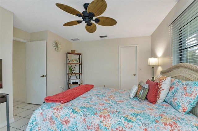 tiled bedroom with ceiling fan