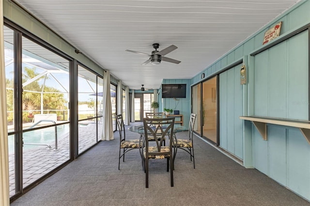 sunroom featuring a wealth of natural light and ceiling fan