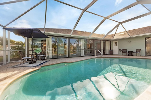 view of pool featuring a patio and glass enclosure