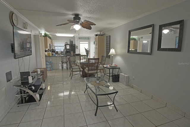 tiled living room featuring ceiling fan, a textured ceiling, and ornamental molding