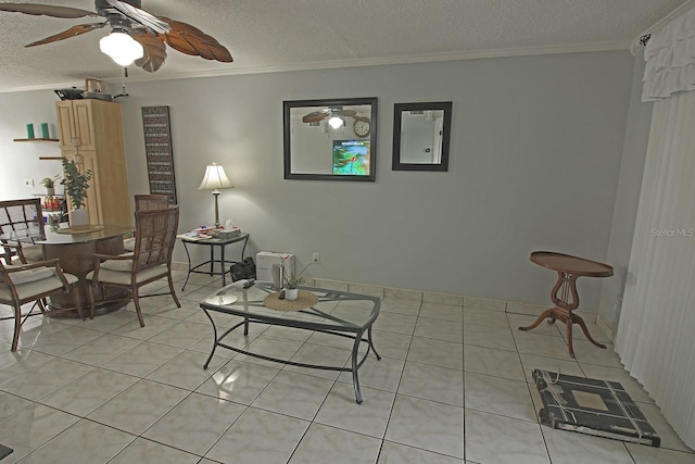 tiled living room with ceiling fan, electric panel, ornamental molding, and a textured ceiling