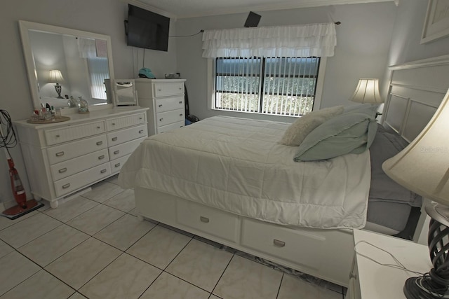 tiled bedroom featuring ornamental molding