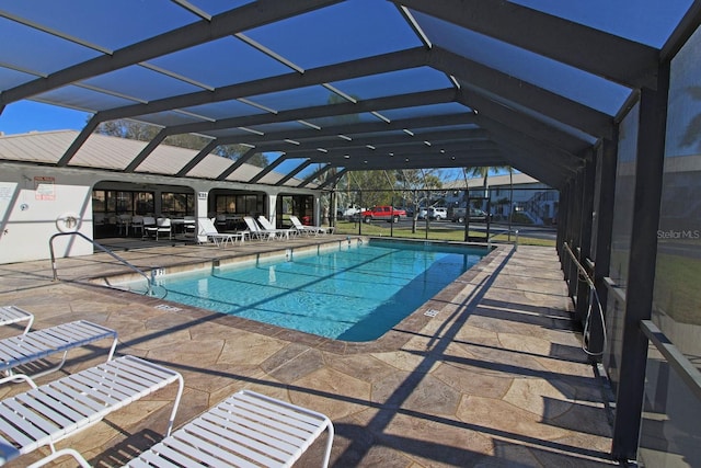 view of pool with a lanai and a patio area