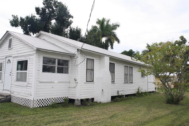 rear view of property with a yard