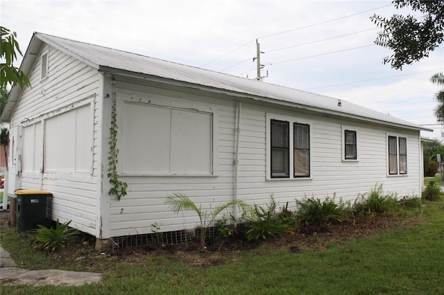 view of side of property with a yard