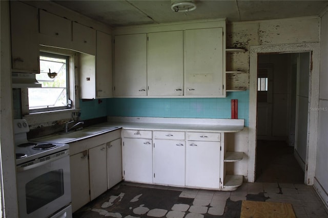 kitchen featuring ventilation hood, sink, electric range, and white cabinetry