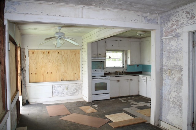 kitchen featuring white cabinets, ceiling fan, electric range, and sink