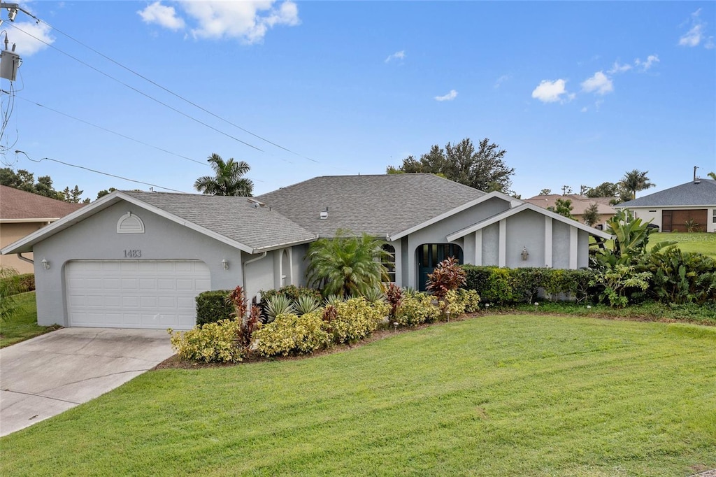 ranch-style house featuring a garage and a front yard