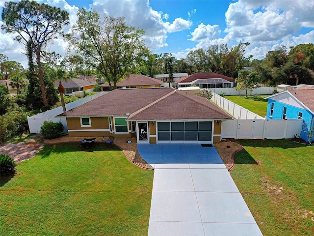 ranch-style house featuring a garage and a front lawn